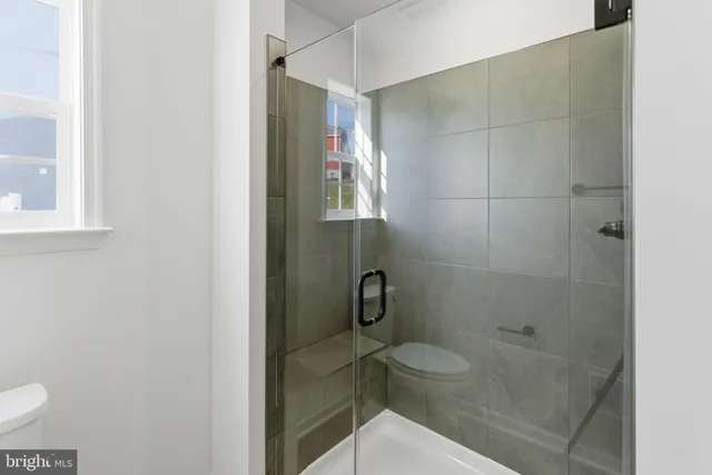 a bathroom with a toilet and a shower