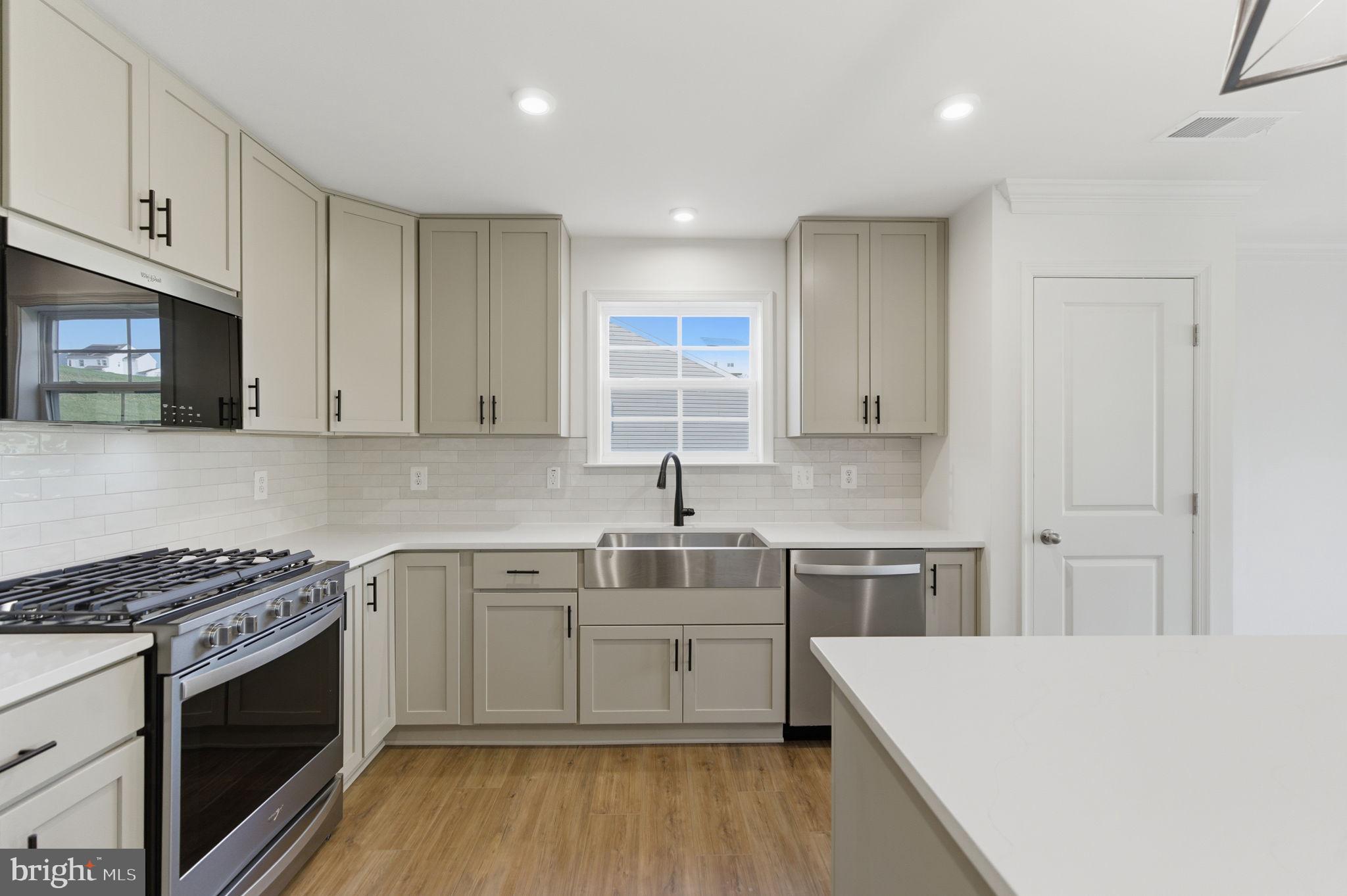 205 Pheasant Ridge Road Hanover, PA 17331 - Photo 7 of 27 a kitchen with a sink stove top oven and cabinets