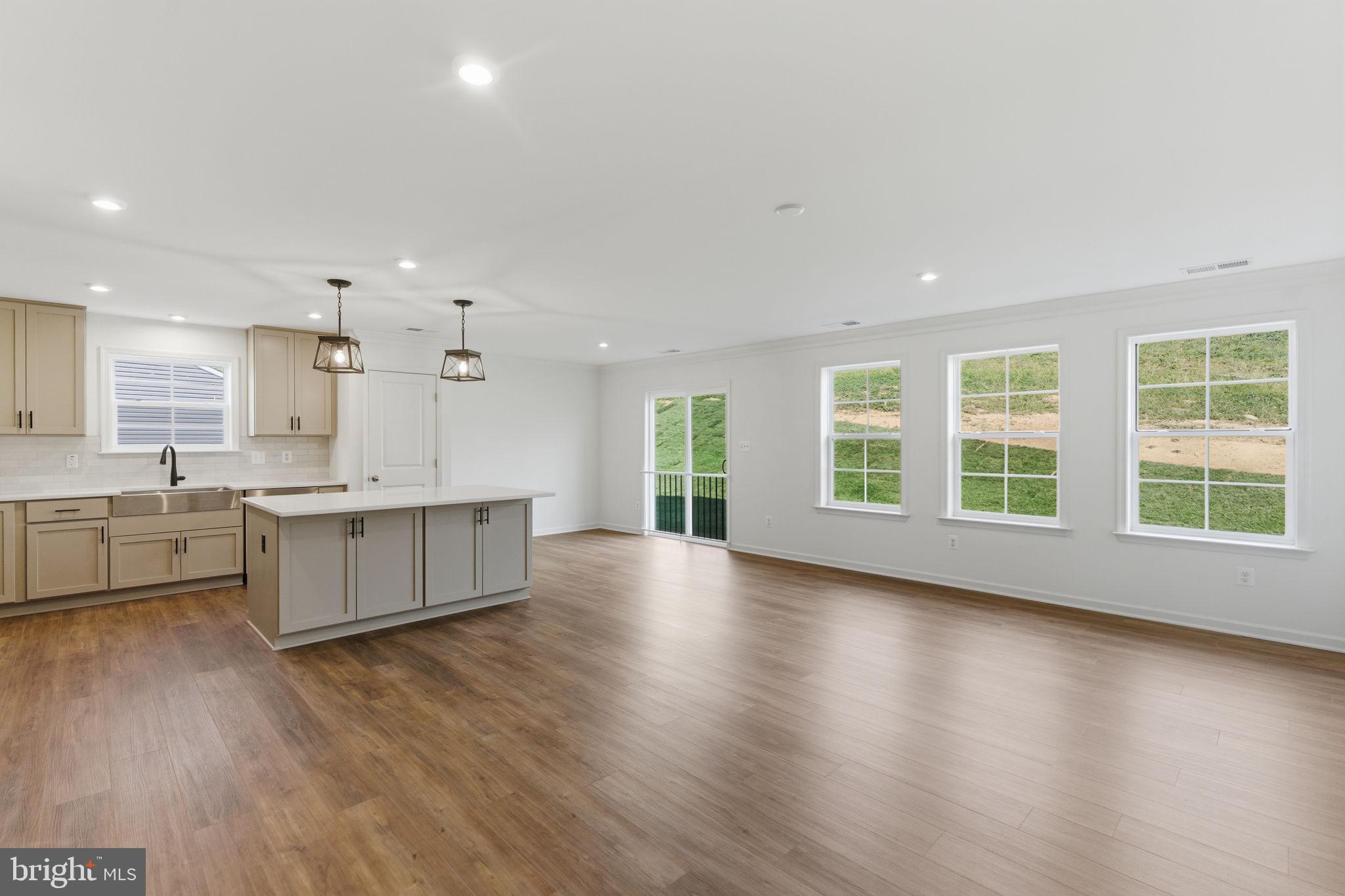 205 Pheasant Ridge Road Hanover, PA 17331 - Photo 9 of 27 a large living room with stainless steel appliances kitchen island wooden floors and white walls