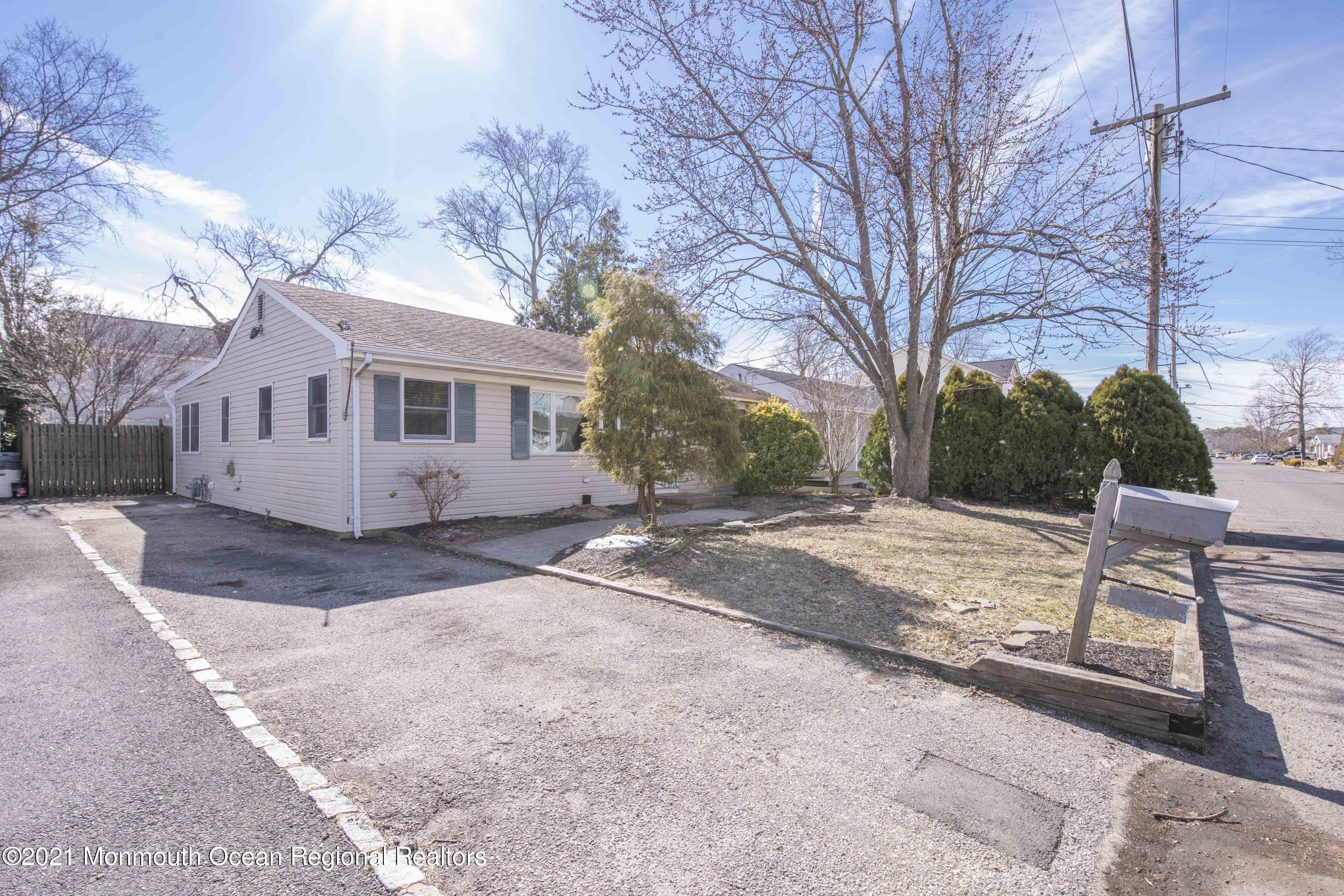 3208 Kickapoo Avenue Point Pleasant, NJ 08742 - Photo 2 of 23 a view of a house with a yard and a large tree