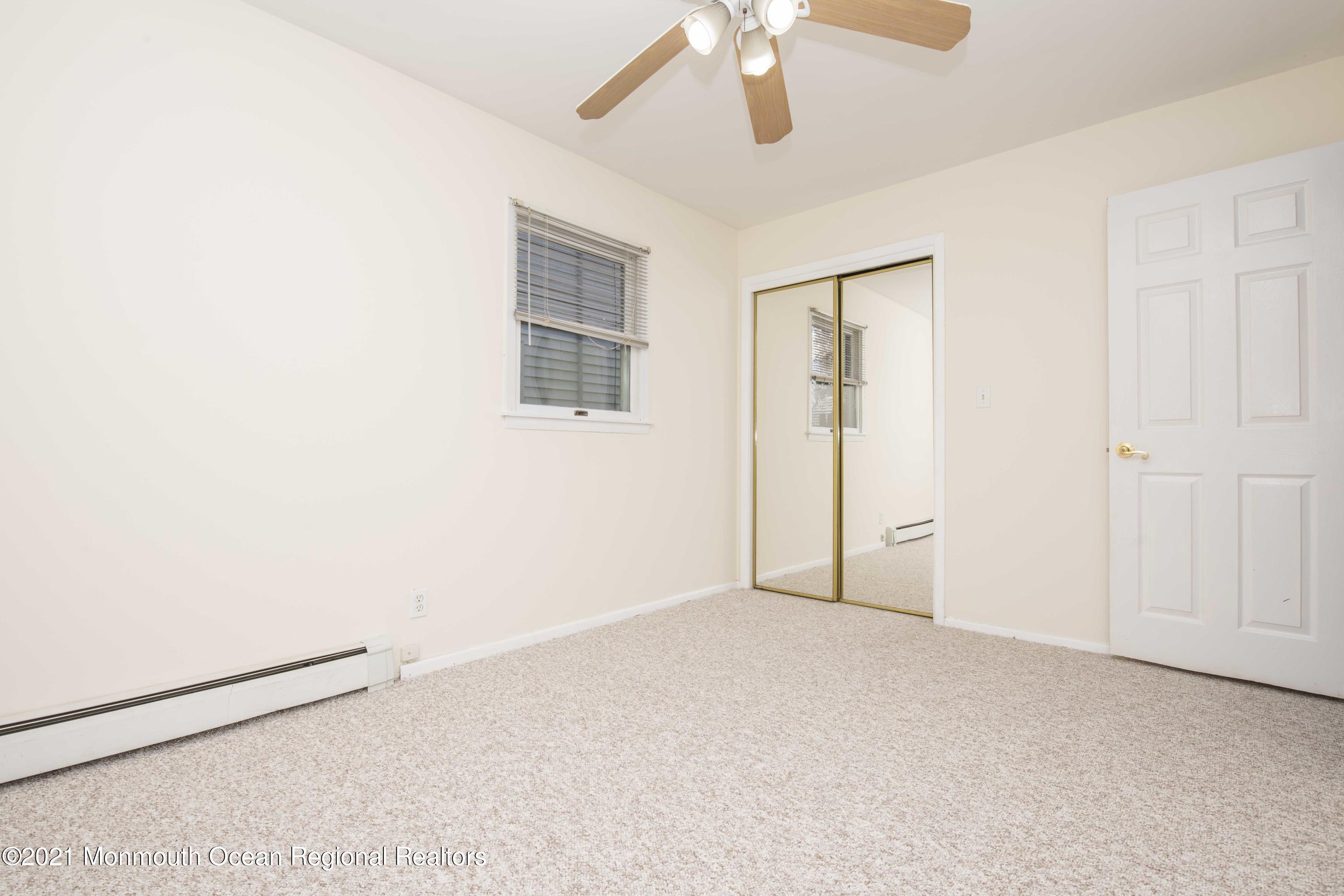 3208 Kickapoo Avenue Point Pleasant, NJ 08742 - Photo 12 of 23 an empty room with windows and fan