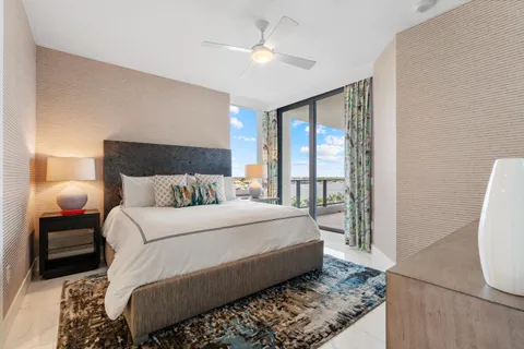 a living room with furniture a couch and a large window