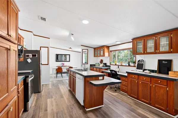 a kitchen with stainless steel appliances granite countertop a refrigerator stove and sink