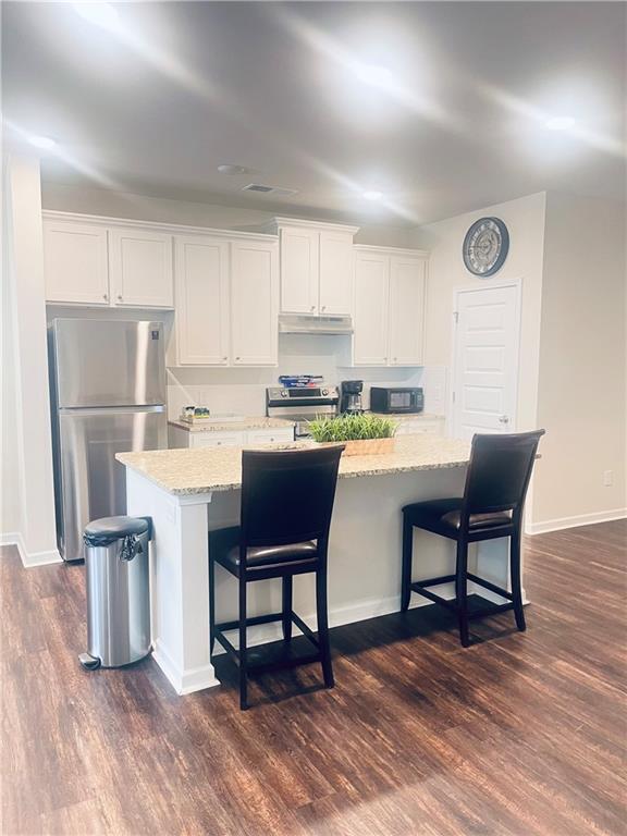 300 Harrison Street Calhoun, GA 30701 - Photo 6 of 17 a kitchen with a dining table chairs and refrigerator