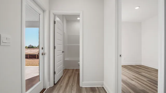 a view of a hallway with wooden floor