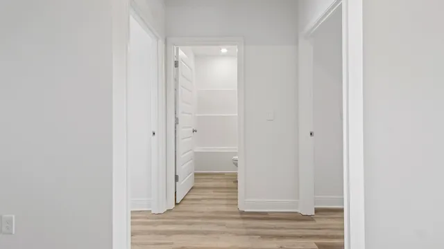 a view of a bathroom from a hallway