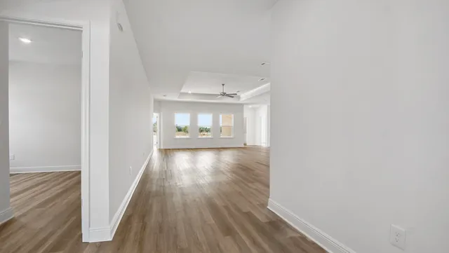 a view of hallway with wooden floor