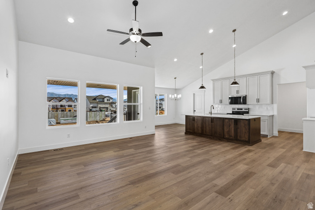 1139 South 4475 West West Point, UT 84015 - Photo 32 of 33 Kitchen featuring open floor plan, high vaulted ceiling, pendant lighting, recessed lighting, and a chandelier