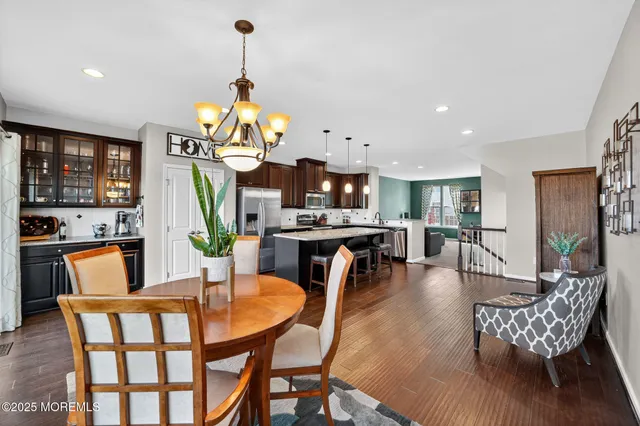 a dining room with furniture a rug and a chandelier