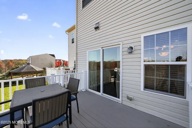 a view of a deck with table and chairs and wooden floor