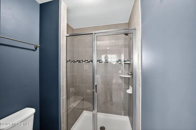 a bathroom with a glass shower door