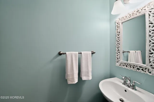 a bathroom with a sink and mirror