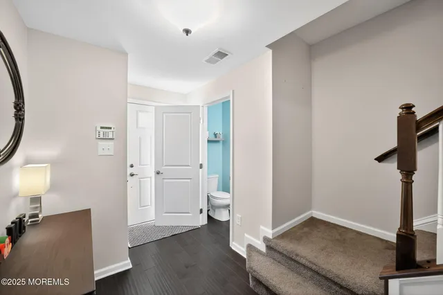 a view of a room with entryway and wooden floor