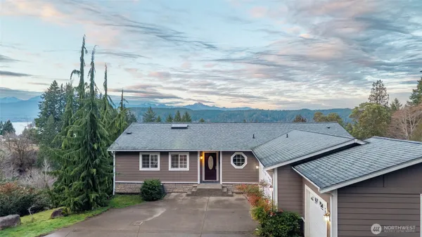 a aerial view of a house next to a yard