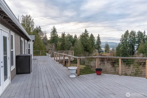 an aerial view of a house with a yard from a lake view