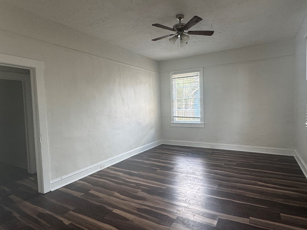 16 29th Street Columbus, GA 31904 - Photo 2 of 12 an empty room with wooden floor and windows