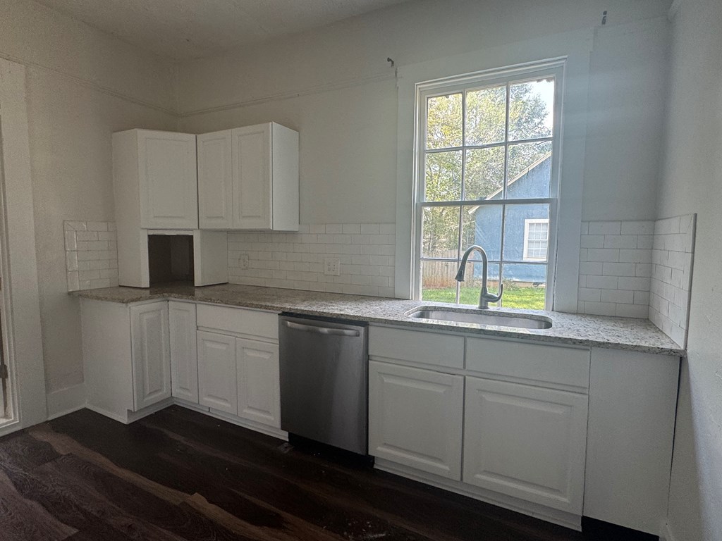 16 29th Street Columbus, GA 31904 - Photo 5 of 12 a kitchen with a sink window and cabinets