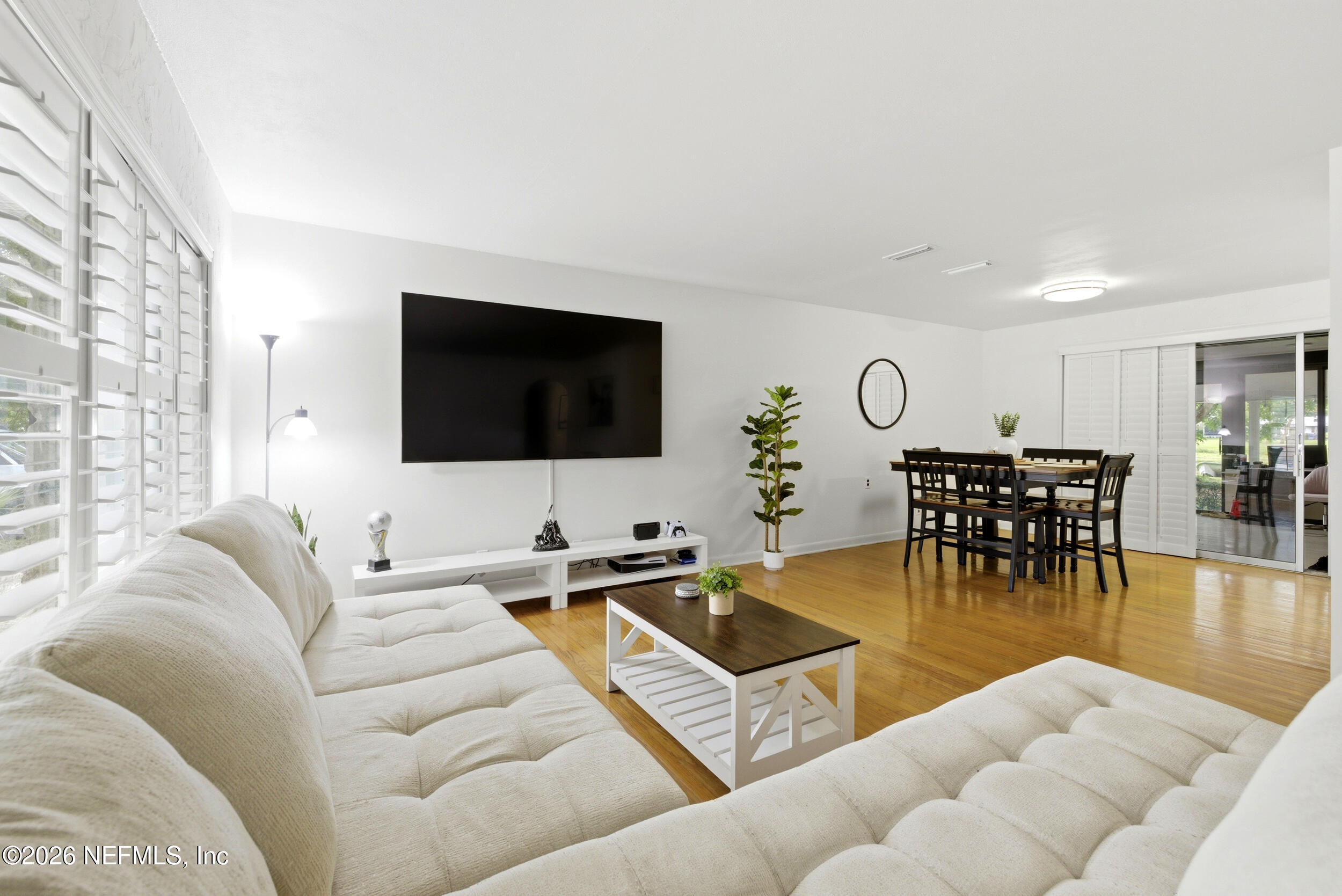 7484 Spinola Road Jacksonville, FL 32217 - Photo 10 of 63 a living room with furniture and a flat screen tv