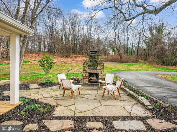 a view of backyard with seating area and trees