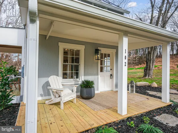 a view of a porch with a table and chairs