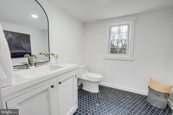 a bathroom with a sink toilet and mirror