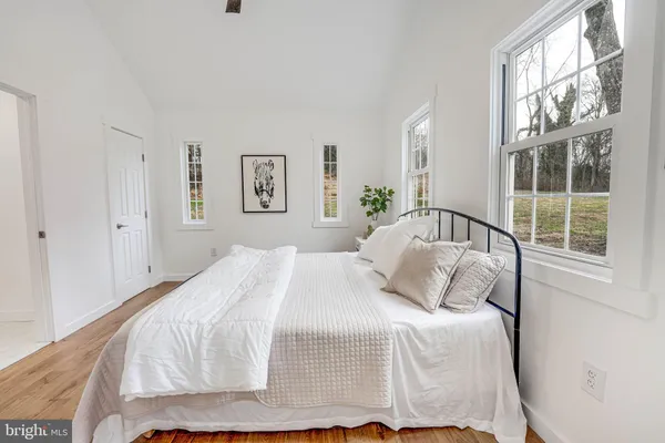 a bedroom with a bed and a large window