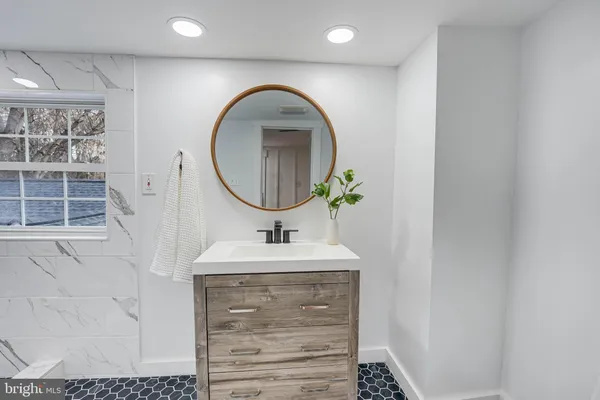 a bathroom with a sink and a mirror