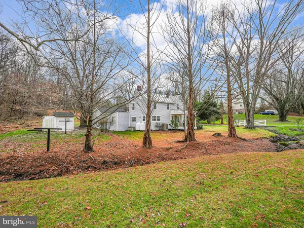 a view of a yard with a house in the background