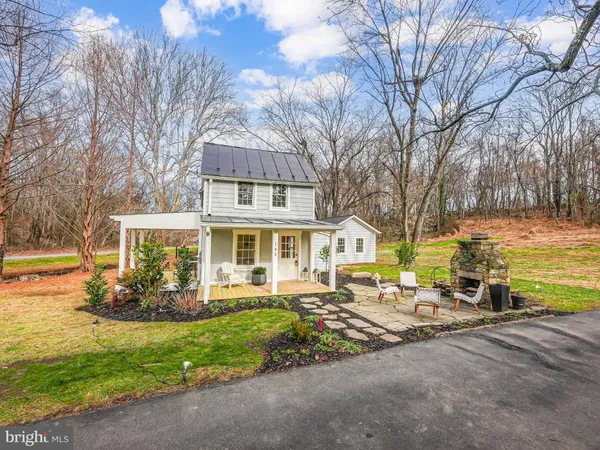 a front view of house with yard and outdoor seating
