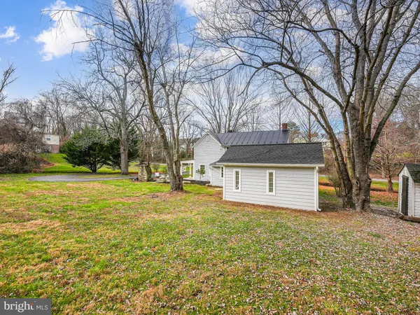 a front view of house with yard and trees