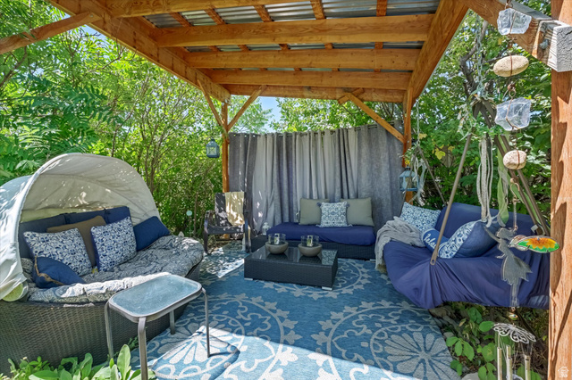 510 Spring Creek Road Providence, UT 84332 - Photo 54 of 97 Outdoor wooden pergola featuring a corrugated metal roof, privacy curtains, and a patterned area rug