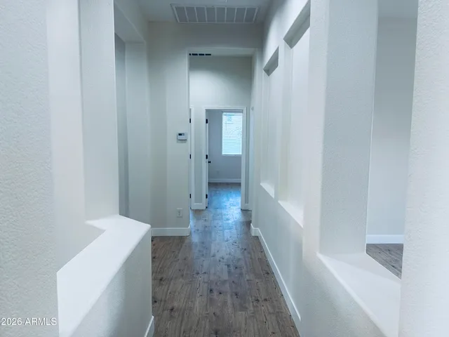 a view of hallway with wooden floor