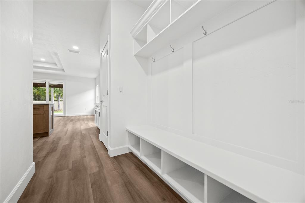 1099 Southwest 66th Terrace Gainesville, FL 32607 - Photo 21 of 35 a hallway view with wooden floor and staircase