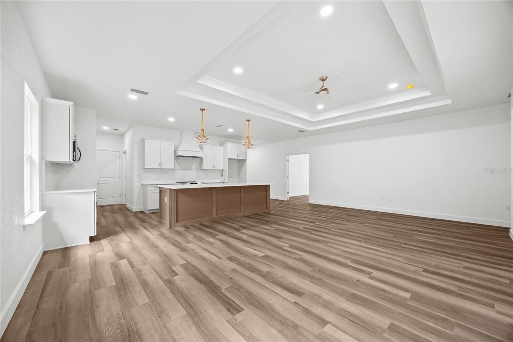 1099 Southwest 66th Terrace Gainesville, FL 32607 - Photo 28 of 35 a view of kitchen with kitchen island wooden floor center island and stainless steel appliances