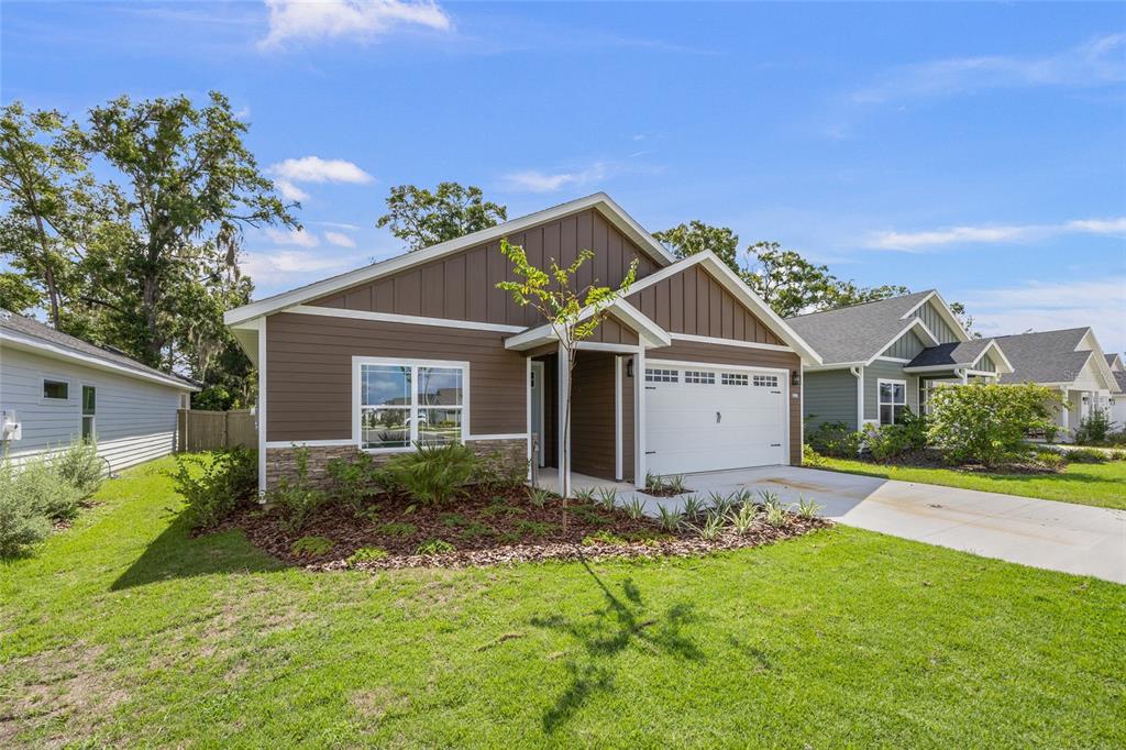 1099 Southwest 66th Terrace Gainesville, FL 32607 - Photo 3 of 35 a view of a house with a big yard and large tree