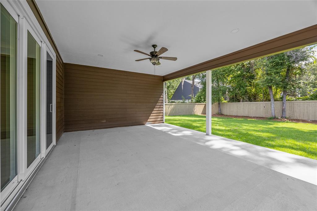 1099 Southwest 66th Terrace Gainesville, FL 32607 - Photo 5 of 35 a view of a room with wooden floor and a ceiling fan