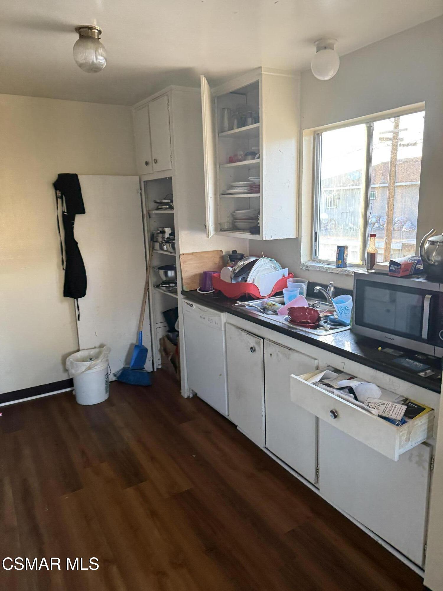 331 Campbell Way Oxnard, CA 93033 - Photo 6 of 14 a kitchen with blue cabinets and window