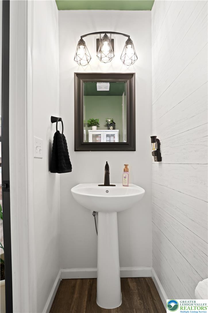 2336 Alex Road Easton, PA 18040 - Photo 10 of 35 A sleek pedestal sink with dark fixtures adds contemporary style to this compact powder room.