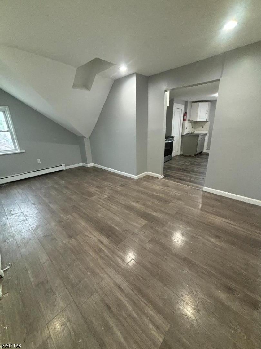 76 Jasper Street Paterson, NJ 07522 - Photo 2 of 12 a view of an empty room and a kitchen