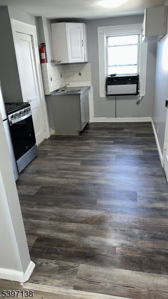 76 Jasper Street Paterson, NJ 07522 - Photo 3 of 12 a view of kitchen with wooden floor and electronic appliances