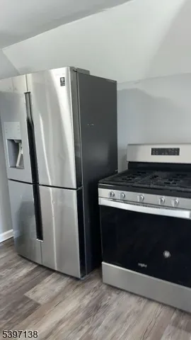 a view of a fridge with wooden floor
