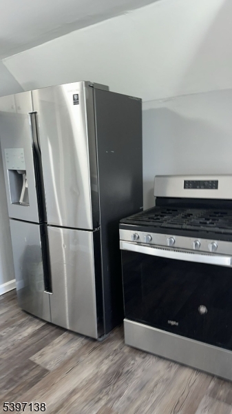 76 Jasper Street Paterson, NJ 07522 - Photo 4 of 12 a view of a fridge with wooden floor