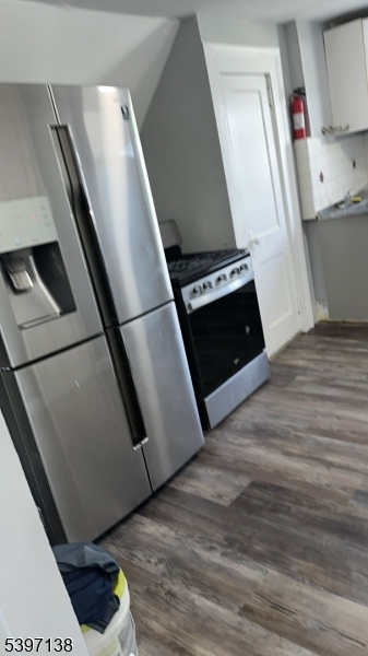 76 Jasper Street Paterson, NJ 07522 - Photo 5 of 12 a view of an empty room with wooden floor