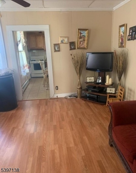 76 Jasper Street Paterson, NJ 07522 - Photo 7 of 12 a living room with furniture and a flat screen tv