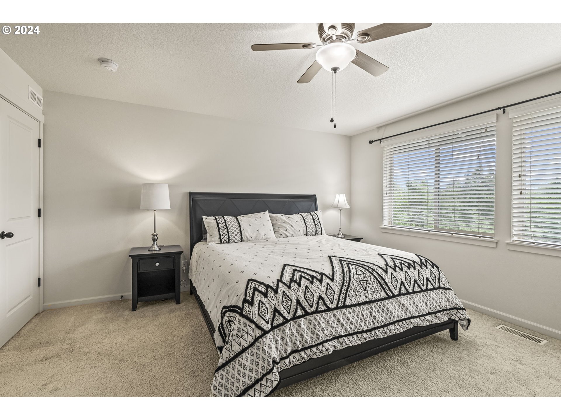 266 North Green Gables Loop Ridgefield, WA 98642 - Photo 20 of 37 a bedroom with a bed and a chandelier