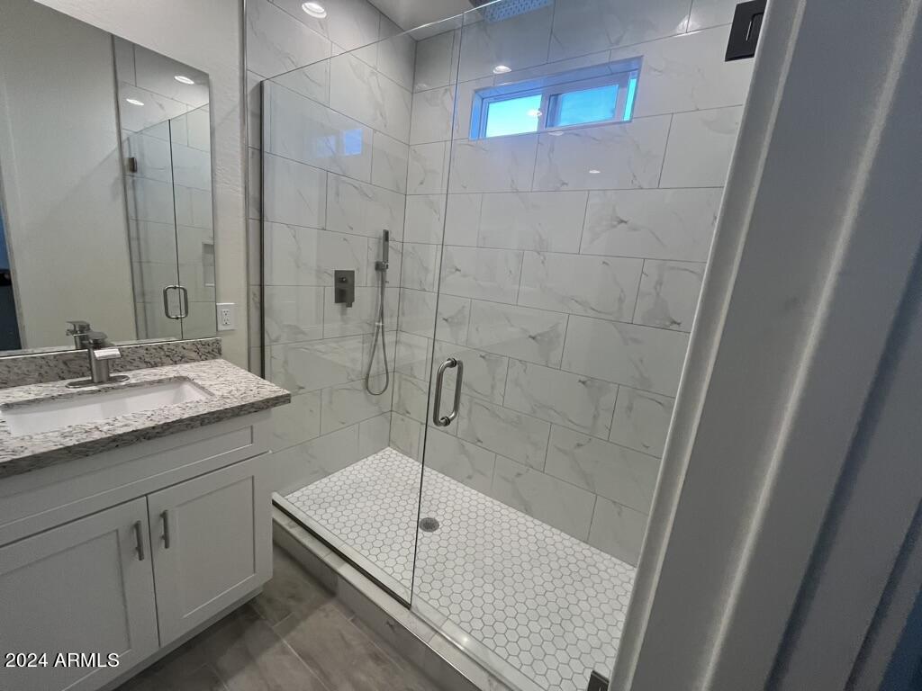 15200 South Diablo Road Arizona City, AZ 85123 - Photo 21 of 23 a bathroom with a granite countertop sink a toilet and shower