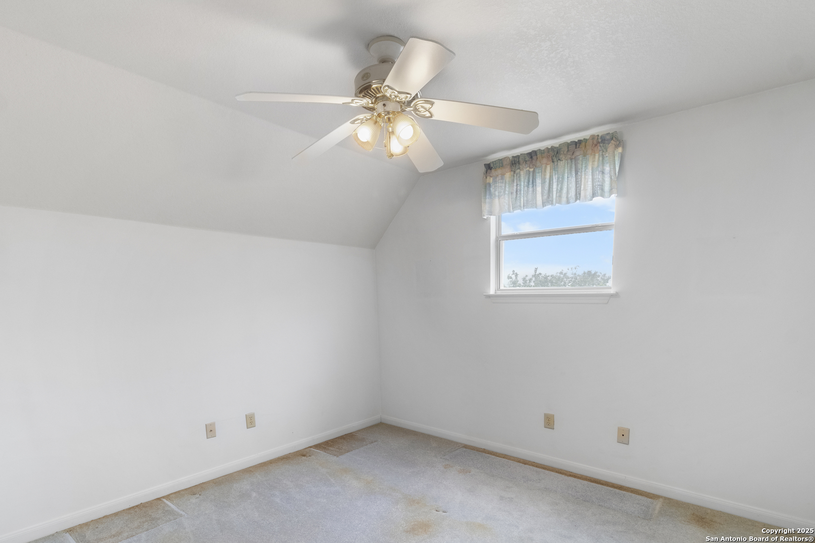 369 Deer Valley Bandera, TX 78003 - Photo 18 of 34 an empty room with a window and chandelier fan