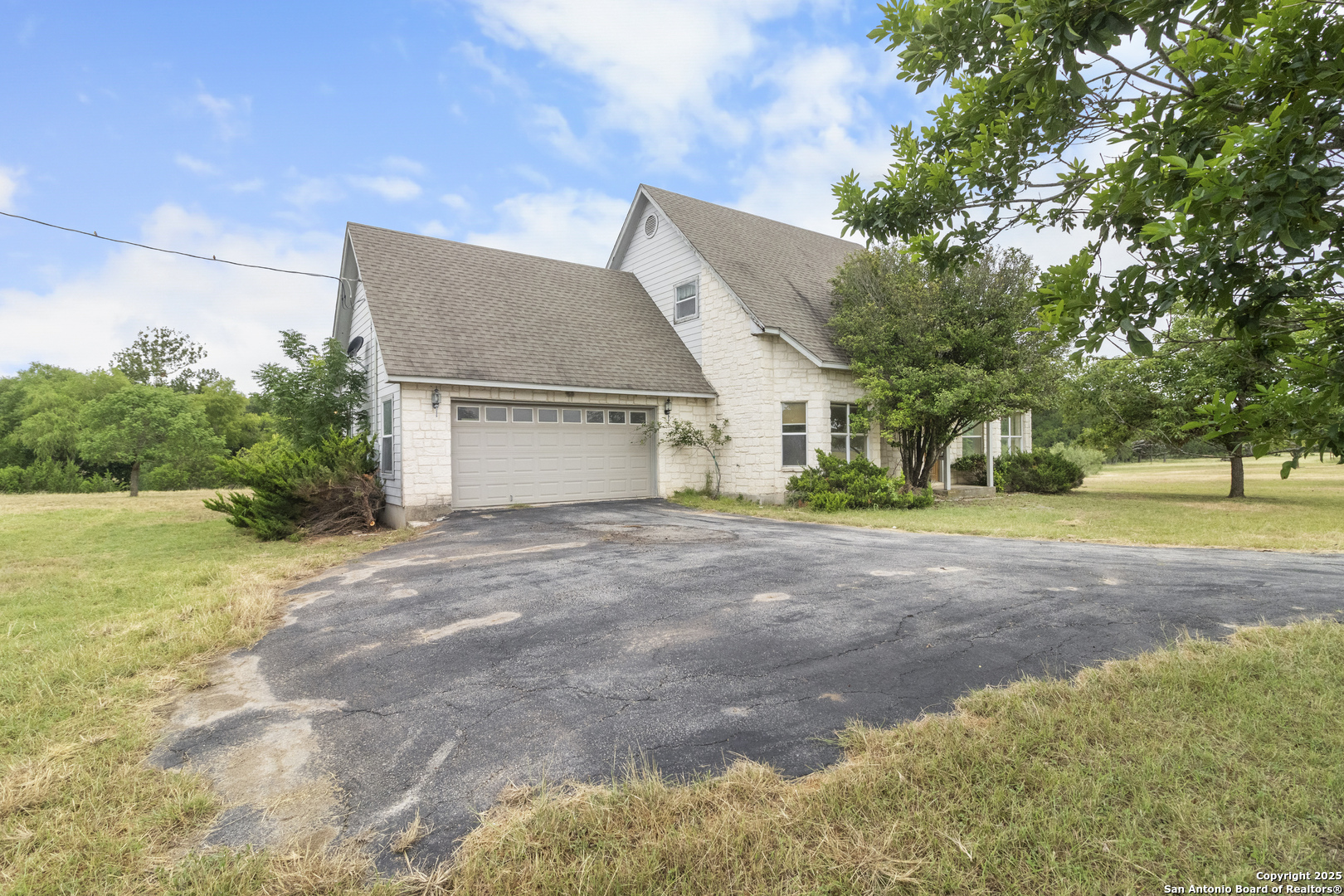 369 Deer Valley Bandera, TX 78003 - Photo 2 of 34 a view of a house with backyard and trees
