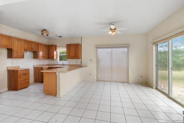 a large kitchen with cabinets and stainless steel appliances