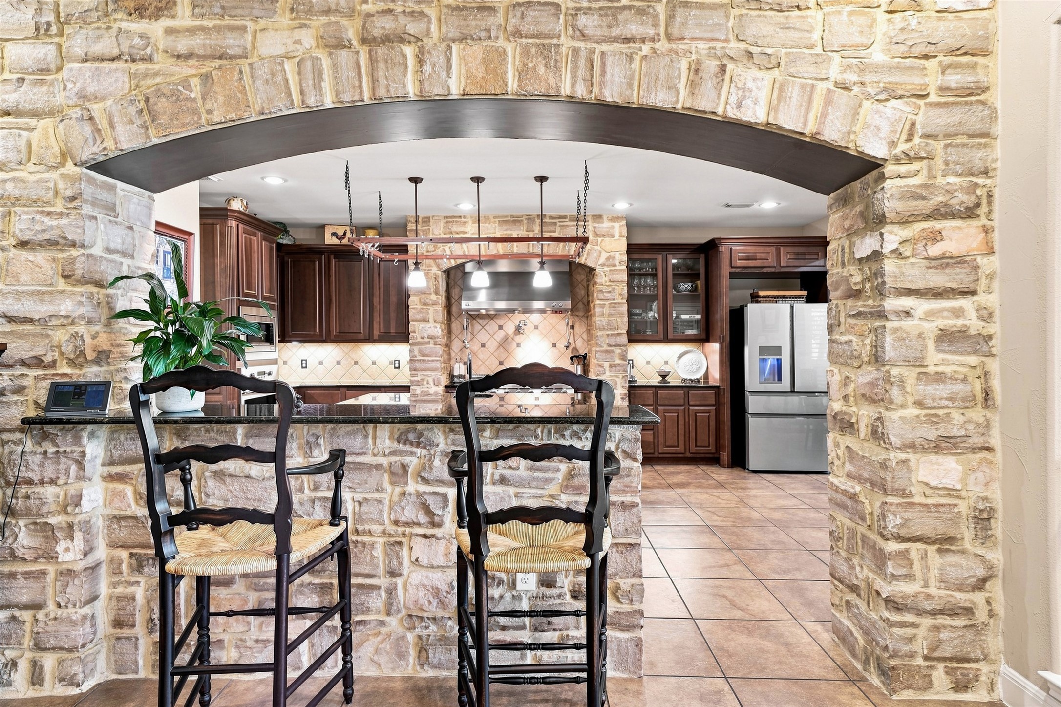 402 Ridgetop Bend Cedar Park, TX 78613 - Photo 14 of 40 A dramatic stone archway frames the view into this beautifully appointed kitchen.